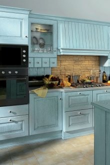 Μπεζ ποδιά και πλακάκια και ένα μπλε σετ στην κουζίνα