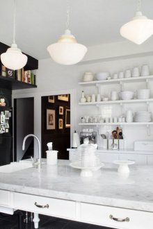 Μαύρη και άσπρη κουζίνα με νησί.