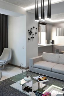 Οι συνδυασμένοι χώροι της κουζίνας και του καθιστικού σε γκρίζα χαλαρωτικά χρώματα