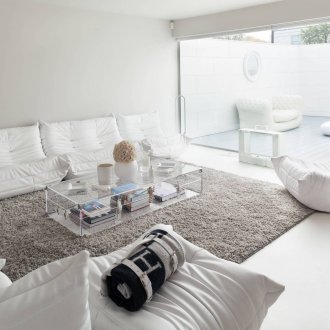 Γκρι χνουδωτό χαλί στο φωτεινό εσωτερικό του καθιστικού