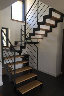 Σκάλες στον δεύτερο όροφο του σπιτιού σε ένα μαύρο μεταλλικό σκελετό