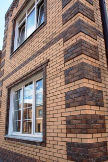 Ο συνδυασμός του σκούρου και ελαφρού τούβλου επένδυσης στο εξωτερικό του σπιτιού